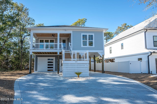 view of front of home with a porch, a garage, and ceiling fan