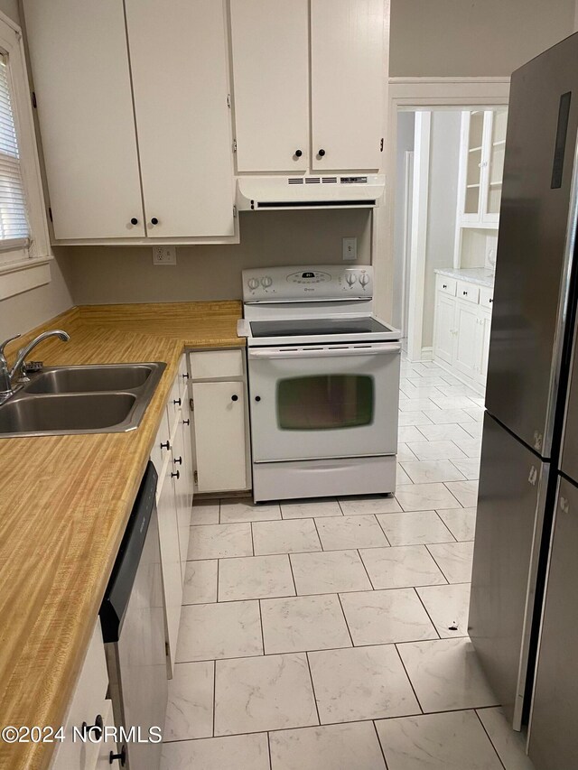 kitchen featuring ventilation hood, white cabinets, stainless steel appliances, and sink