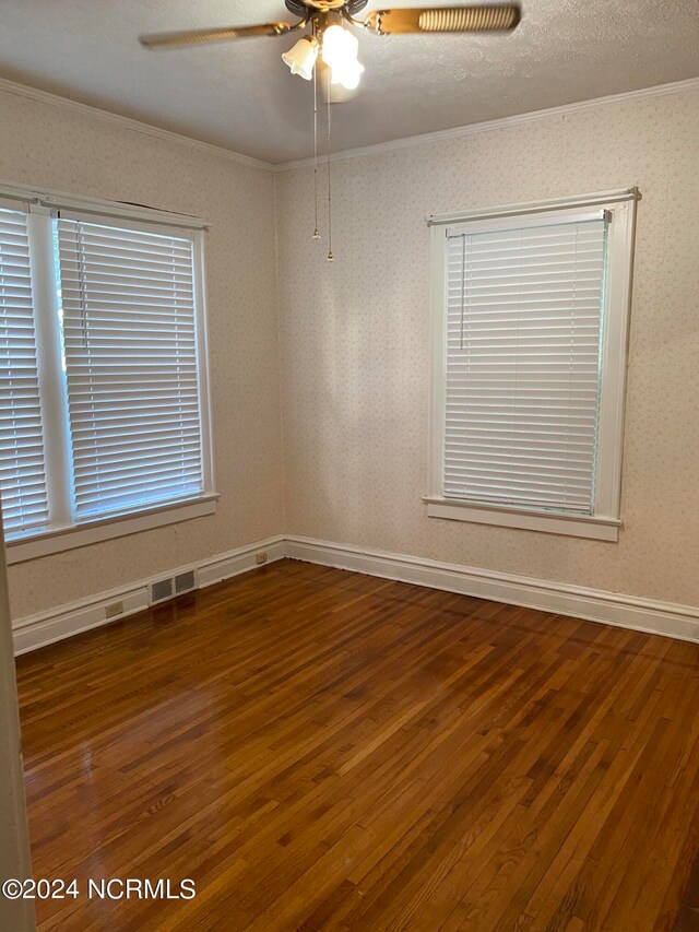 unfurnished room with ceiling fan, hardwood / wood-style flooring, crown molding, and a textured ceiling