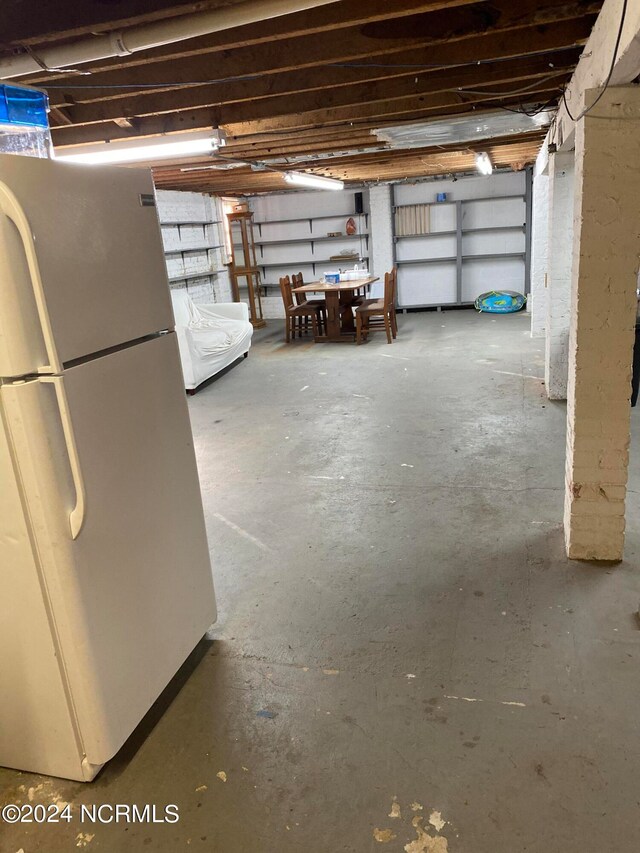 basement with white fridge