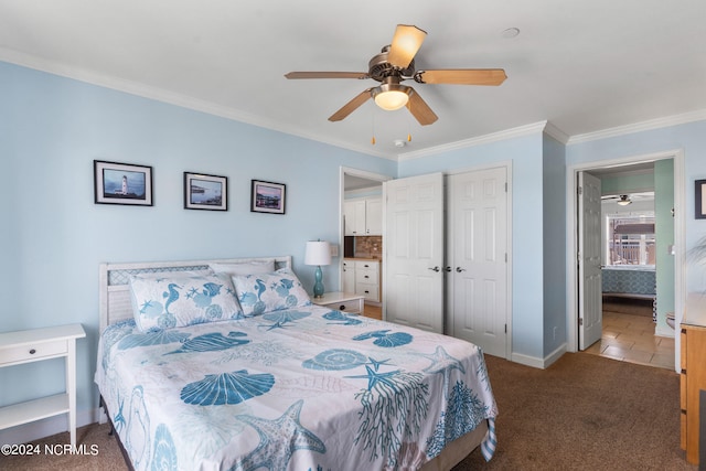 carpeted bedroom featuring crown molding, a closet, and ceiling fan