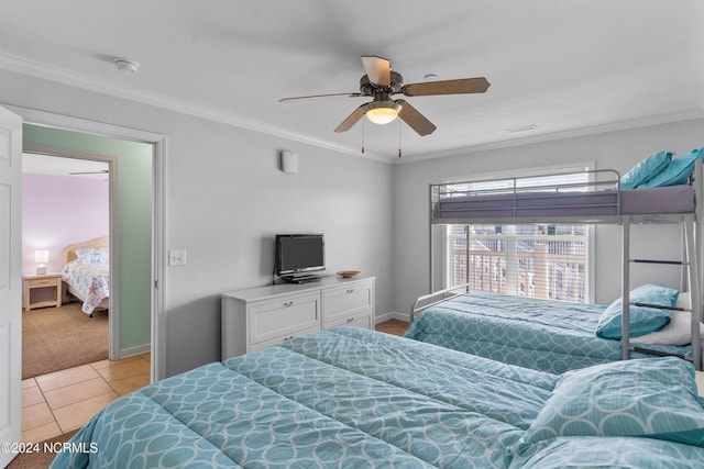 carpeted bedroom featuring crown molding and ceiling fan