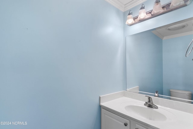 bathroom with vanity, ornamental molding, and toilet