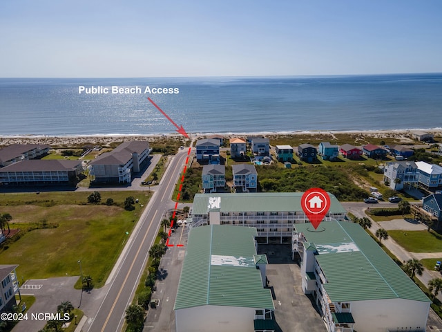 aerial view with a water view and a beach view