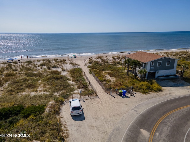 drone / aerial view featuring a view of the beach and a water view