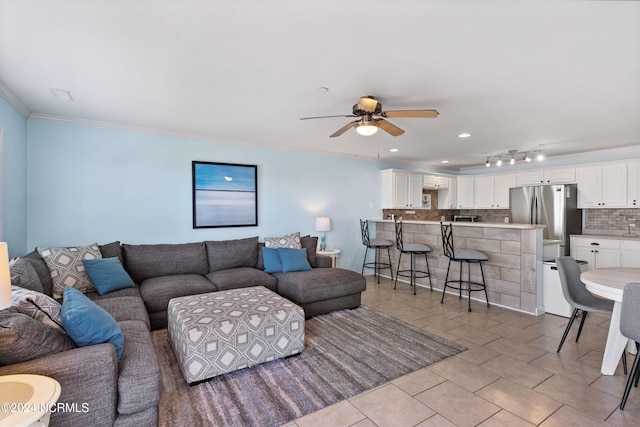 living room featuring ceiling fan and ornamental molding