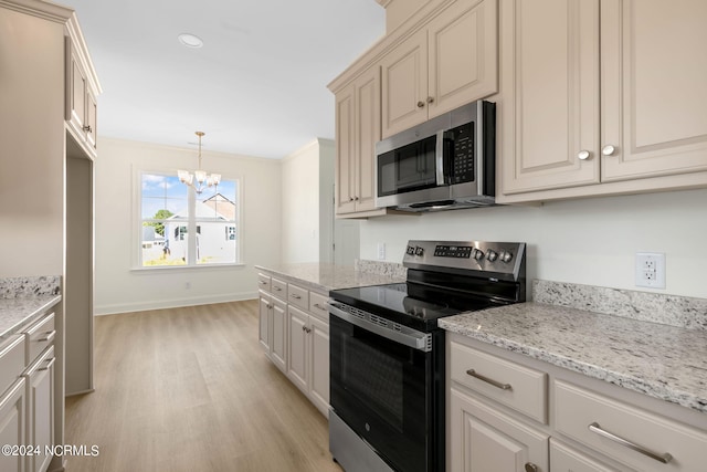 kitchen featuring appliances with stainless steel finishes, hanging light fixtures, light hardwood / wood-style floors, light stone counters, and an inviting chandelier