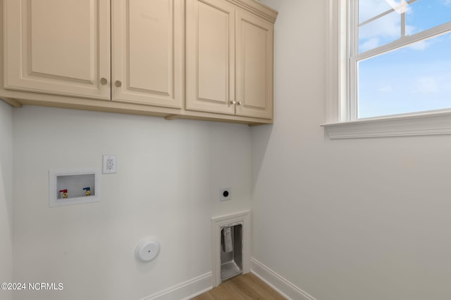 washroom with cabinets, light hardwood / wood-style flooring, washer hookup, and electric dryer hookup