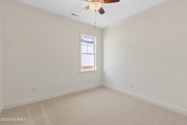 empty room with crown molding, carpet, and ceiling fan