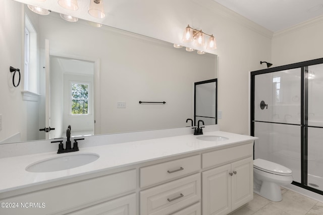 bathroom featuring toilet, ornamental molding, a shower with shower door, vanity, and tile patterned flooring