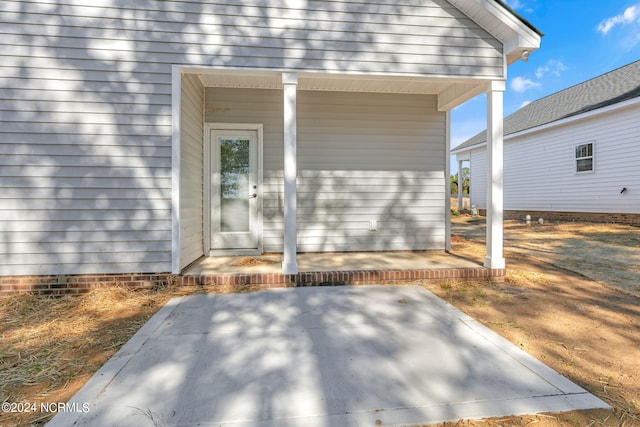 doorway to property with a patio area