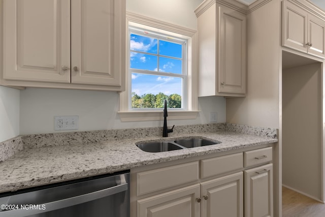 kitchen featuring dishwasher, wood-type flooring, sink, white cabinetry, and light stone counters