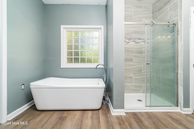 bathroom featuring independent shower and bath and wood-type flooring