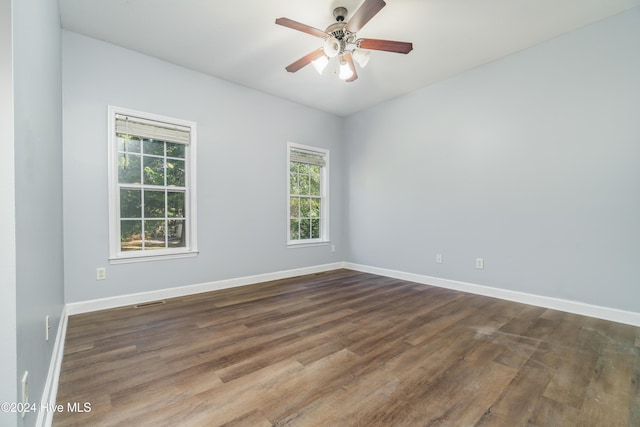 unfurnished room featuring dark hardwood / wood-style floors and ceiling fan