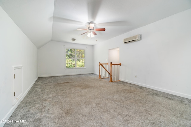 additional living space featuring lofted ceiling, carpet floors, a wall mounted AC, and ceiling fan