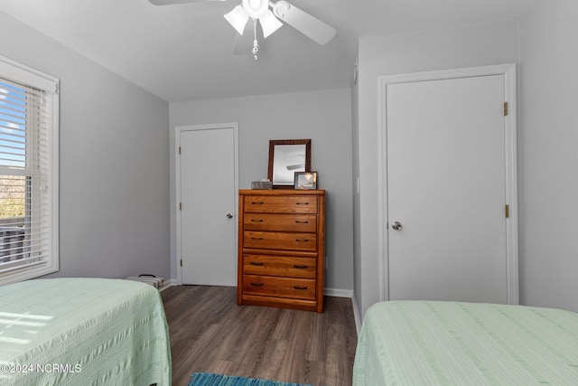 bedroom with ceiling fan and dark hardwood / wood-style floors