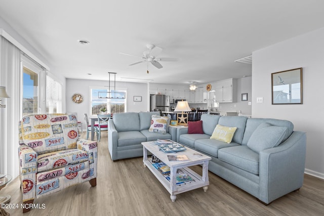 living room featuring ceiling fan and light wood-type flooring