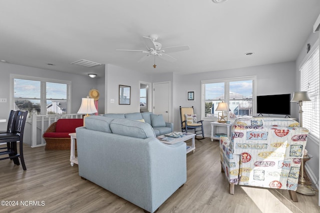 living room featuring light hardwood / wood-style floors, plenty of natural light, and ceiling fan