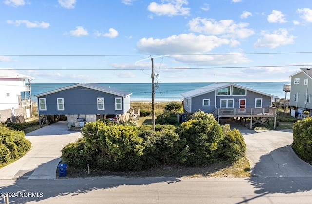 view of front of home with a water view and a carport