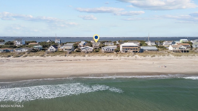 drone / aerial view featuring a view of the beach and a water view