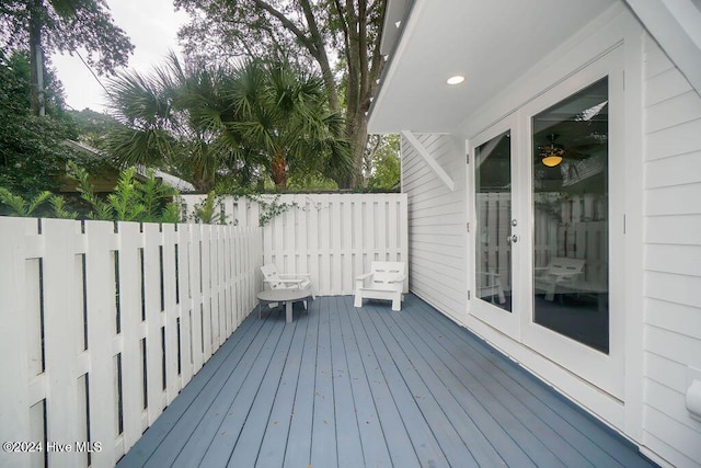 deck featuring fence and french doors