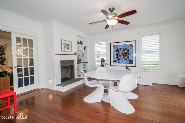 dining area with built in features, dark hardwood / wood-style floors, and plenty of natural light