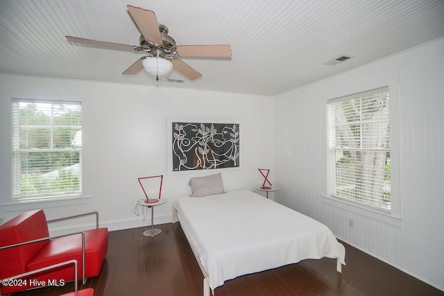 bedroom with wood finished floors, multiple windows, and a ceiling fan