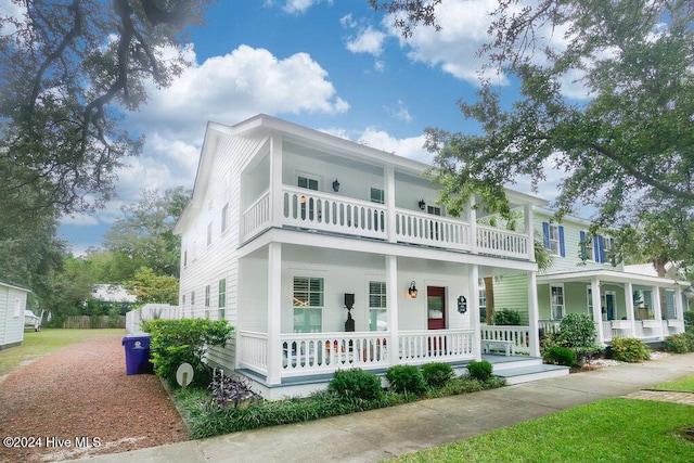 view of front facade with covered porch and a balcony