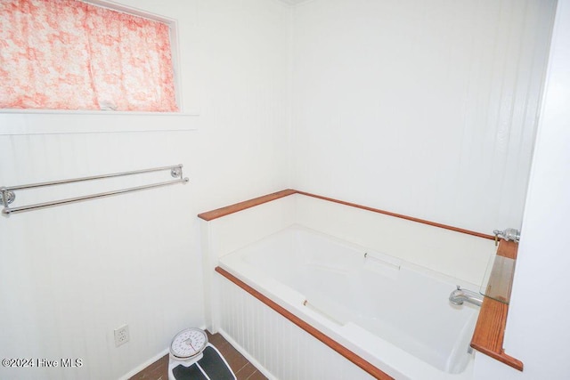 full bath featuring a garden tub and tile patterned floors