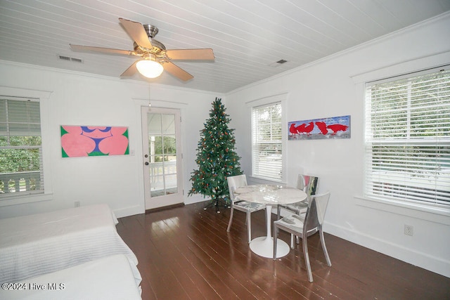 dining room with dark hardwood / wood-style flooring, ceiling fan, and crown molding