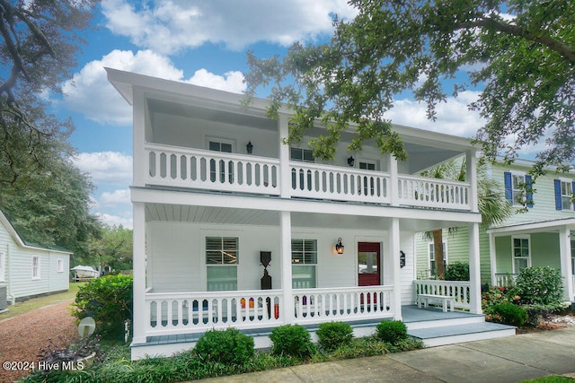 view of front facade featuring a balcony, central AC, and a porch