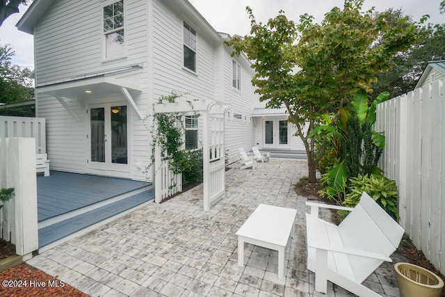 rear view of property with a patio and a wooden deck