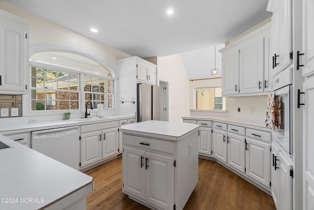 kitchen with white cabinetry, dishwasher, a center island, and dark hardwood / wood-style floors