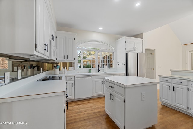 kitchen featuring dishwasher, light wood-type flooring, a center island, stainless steel fridge, and white cabinetry