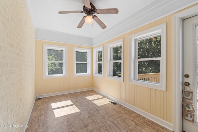 unfurnished sunroom with a healthy amount of sunlight and ceiling fan