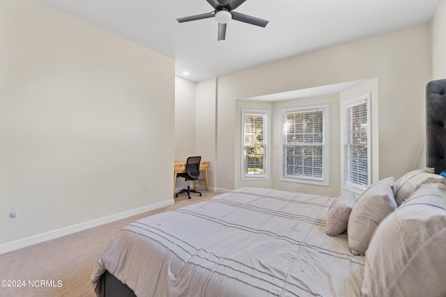 bedroom with ceiling fan and light carpet