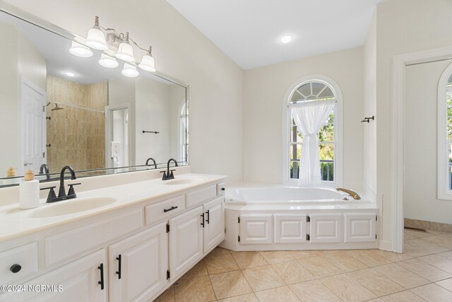 bathroom with vanity, shower with separate bathtub, and tile patterned flooring