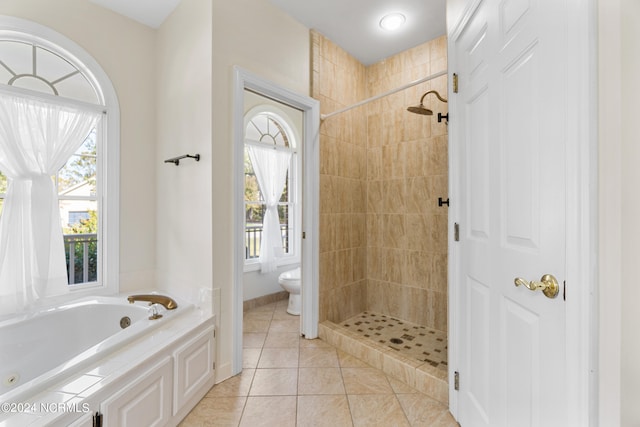 bathroom featuring toilet, independent shower and bath, and tile patterned floors