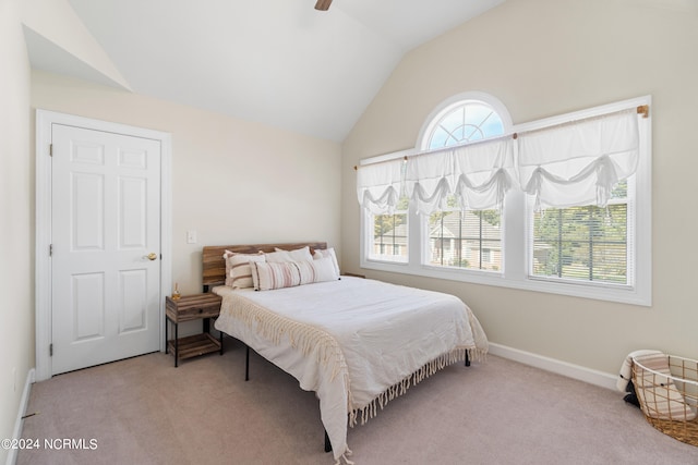 bedroom featuring light carpet, vaulted ceiling, and ceiling fan