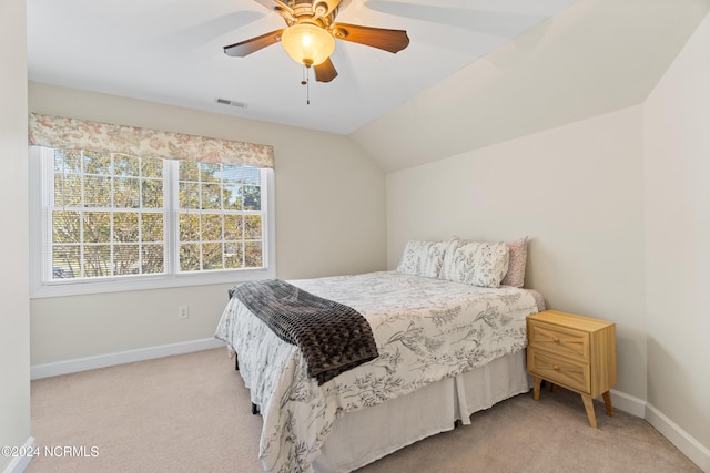 carpeted bedroom featuring vaulted ceiling and ceiling fan