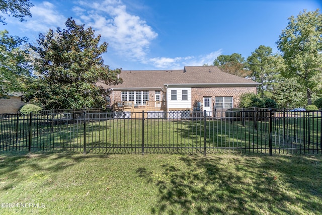 rear view of house featuring a yard