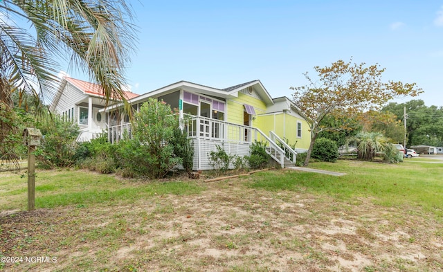 view of side of home with a lawn