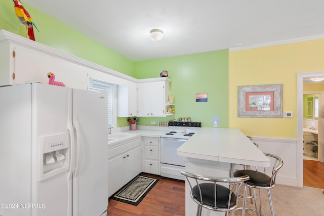 kitchen featuring dark wood-type flooring, ornamental molding, sink, white cabinets, and white appliances