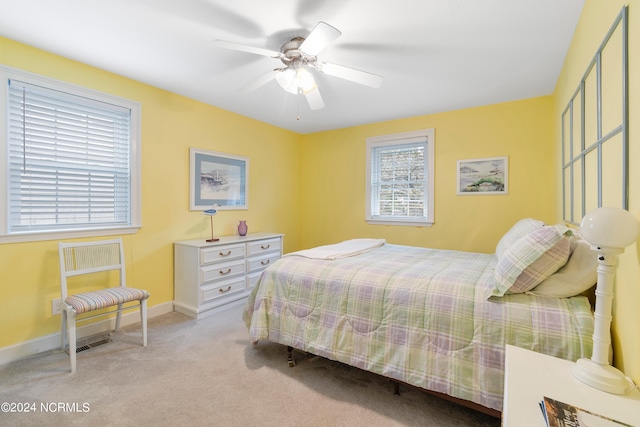 bedroom featuring ceiling fan and light carpet