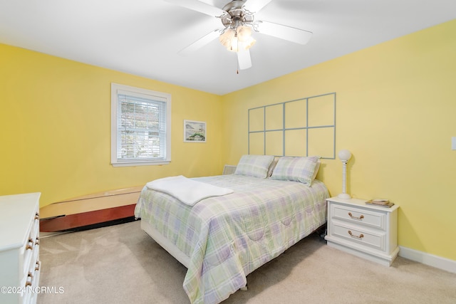 bedroom with ceiling fan and light carpet