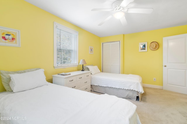 bedroom featuring a closet, ceiling fan, and light carpet