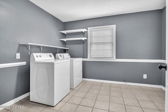 washroom featuring washer and dryer and light tile patterned floors