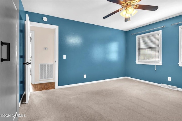 empty room featuring carpet and ceiling fan