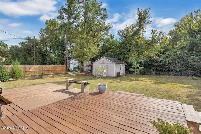 wooden terrace featuring a shed and a lawn