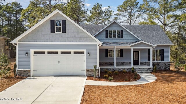 craftsman-style home featuring a porch and a garage